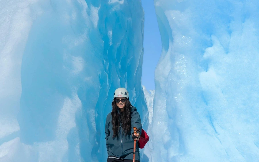 A line of hikers in crampons crossing the ice on Franz Josef Glacier